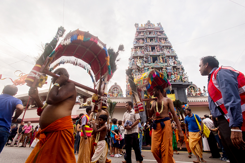 On the eve of Thaipusam in a procession known as Punar Pusam, members of the Nattukottai Chettiar community carry the wooden kavadi and follow the silver chariot procession. In this photograph they are seen outside the Sri Mariamman Temple on South Bridge Road, 2015. Courtesy of T. Kavindran.